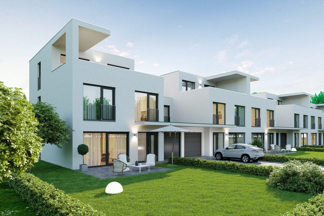 Moderne Reihenhäuser mit grünem Rasen und Pkw auf der Einfahrt.